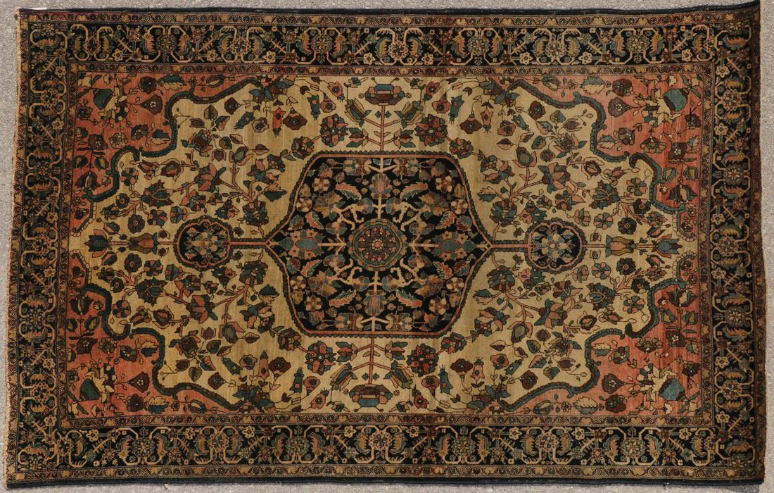 A LARGE FAREHAN SAROUK CARPET C. 1920: A LARGE FAREHAN SAROUK CARPET C. 1920. Medallion pattern at center on ivory field, 76 inches x 49.5 inches. SHIPPING NOTICE: Jackson's is your sole and only source for one stop packing and shipping. W