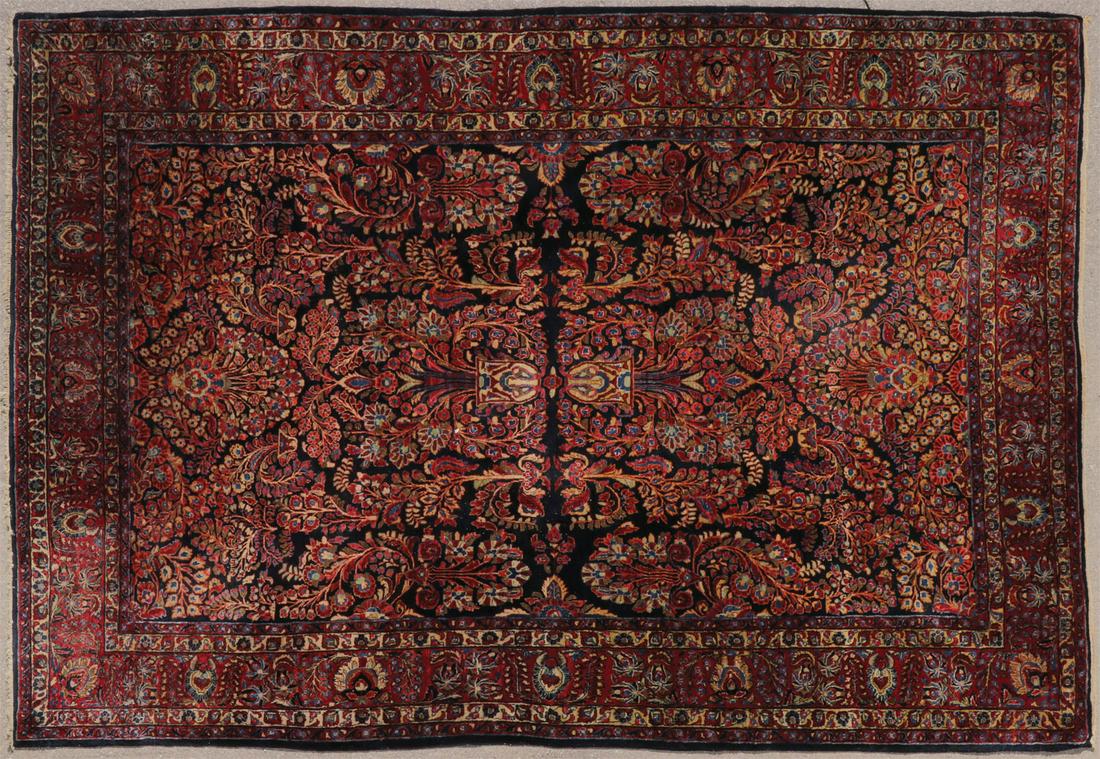 A ROOM SIZE SAROUK CARPET C. 1920: A ROOM SIZE SAROUK CARPET C. 1920. Of symmetrical floral pattern, 144 inches x 105 inches. SHIPPING NOTICE: Jackson's is your sole and only source for one stop packing and shipping. With over 50 years