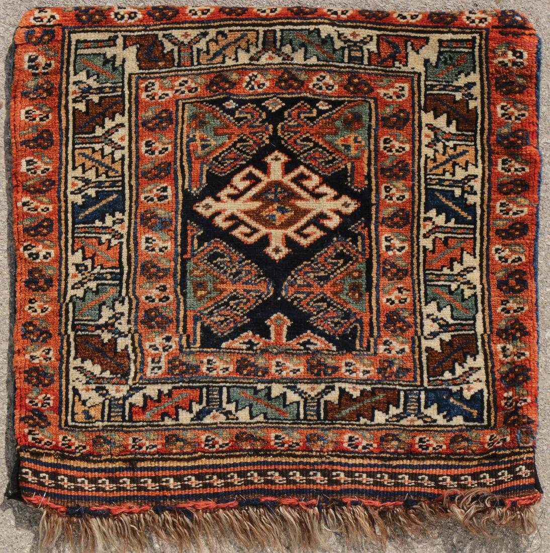 A PAIR OF MIDDLE EASTERN WEAVINGS: A PAIR OF MIDDLE EASTERN WEAVINGS. Comprising a small Kurdish circa 1920, 22.5 inches x 21.5 inches, together with a small Sarouk circa 1920, 23.5 inches x 23.5 inches. SHIPPING NOTICE: Jackson's is y