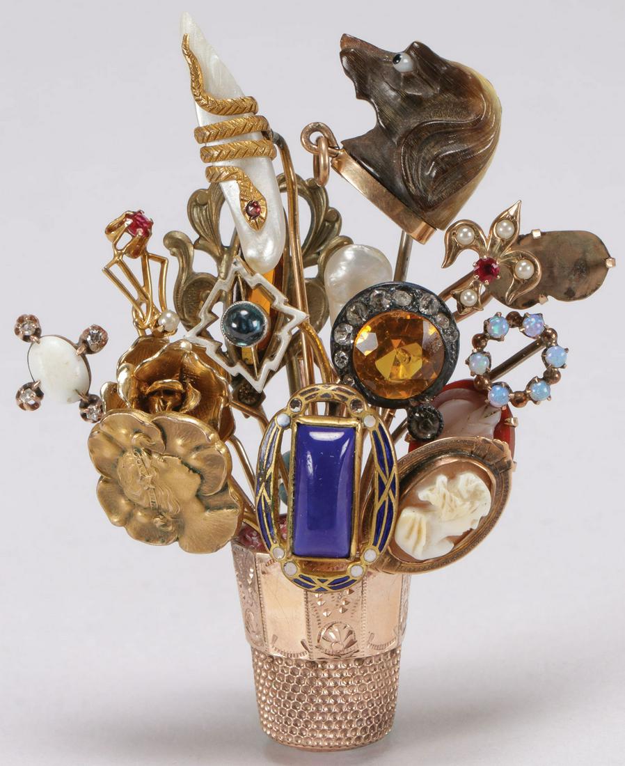 CHARMING GOLD VICTORIAN STICK PIN BROOCH C. 1900: CHARMING GOLD VICTORIAN STICK PIN BROOCH C. 1900. The whimsical vintage brooch with gold thimble "vase" base from which extends 15 stick pins set with various decorative elements including a horn carv