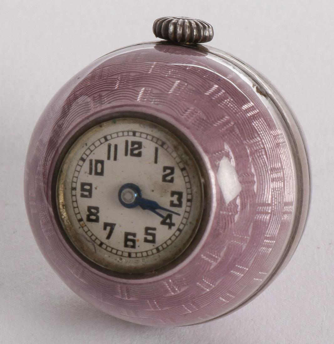 SWISS GUILLOCHE ENAMEL PENDANT BALL WATCH: SWISS GUILLOCHE ENAMEL PENDANT BALL WATCH. The ball-form sterling silver pendant case with lilac guilloche enameling and integral suspension loop. The dial set with Arabic numerals and blued-steel spa