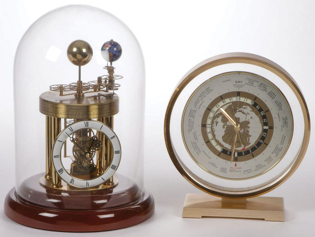 A HERMLE ASTROLABIUM CLOCK: A HERMLE ASTROLABIUM CLOCK. Comprising a battery-operated clock with mahogany base and enamel dial. The quartz regulated astrolabium has a month, and zodiac disc displaying the date and moon cycle in 
