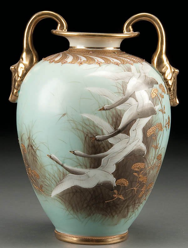 A HAND PAINTED NIPPON SNOW GEESE VASE, early 20th: A HAND PAINTED NIPPON SNOW GEESE VASE, early 20th century, with birds in flight on an aqua ground. Green M in wreath mark. Height 9 inches. Estimate $400-$600