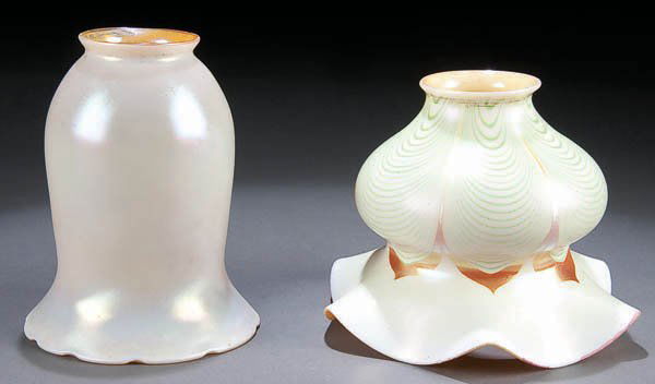 A QUEZAL AND STEUBEN ART GLASS LAMPSHADE, early 2: A QUEZAL AND STEUBEN ART GLASS LAMPSHADE, early 20th century, including a Quezal iridized shade and a Stueben pulled feather shade. Height 5.5 inches and 4.5 inches. Estimate $175-$300