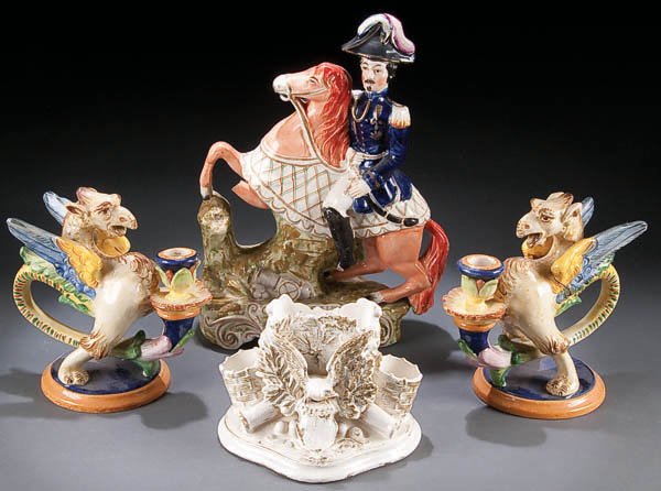 A STAFFORDSHIRE ''GENERAL PELISSIER'' FIGURE, mid: A STAFFORDSHIRE ''GENERAL PELISSIER'' FIGURE, mid 19th century, together with a ''Union Eagle & Shield'' match holder and two Italian Majolica griffin candle stands, some damage and loss. Height 12.5 
