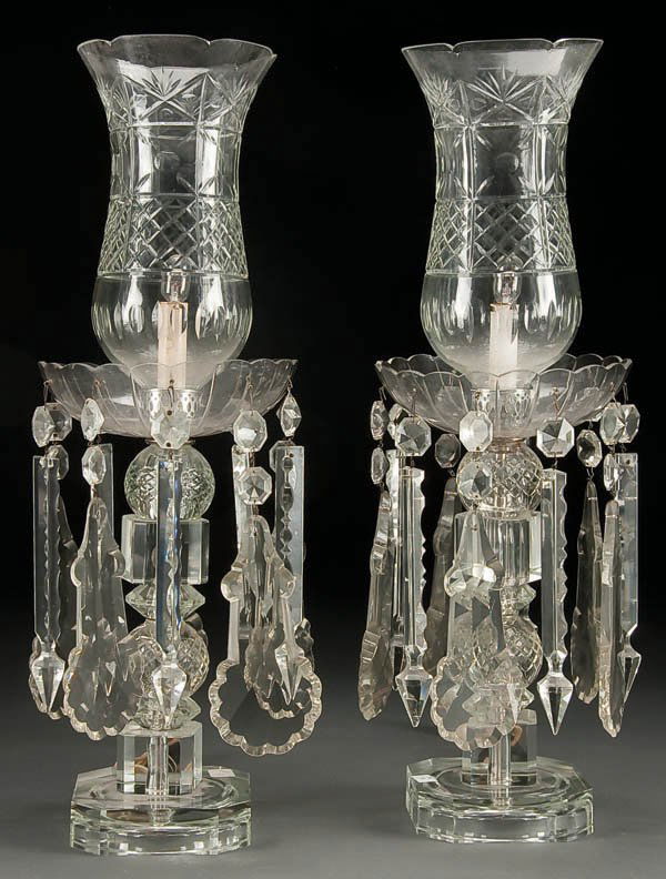 A PAIR OF CUT GLASS MANTLE LUSTERS, early to mid: A PAIR OF CUT GLASS MANTLE LUSTERS, early to mid 20th century, with large cut crystal pendants suspended below a cut glass shade encasing an electric candle socket possibly by Waterford. Height 24 inc
