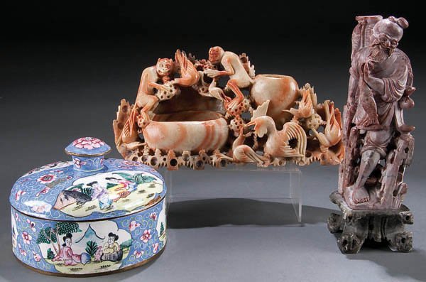 A CHINESE CANTON ENAMELED BRONZE COVERED BOX, cir: A CHINESE CANTON ENAMELED BRONZE COVERED BOX, circa 1900, with garden scenes and foliate scrolls, together with a carved soapstone figure of a fisherman and rockery of monkeys, height 9 inches, diamet