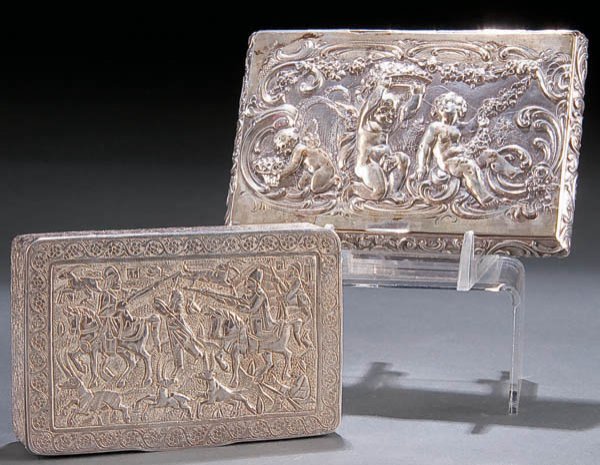 A CONTINENTAL SILVER CIGARETTE CASE circa 1900, w: A CONTINENTAL SILVER CIGARETTE CASE circa 1900, with scene of cupids. Length 4.6 inches x 3.15 inches, together with a Turkish silver cigarette or playing card case- unmarked (20th century). Estimate 