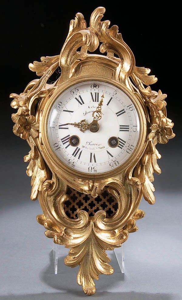 A FINE FRENCH LOUIS XV STYLE GILT BRONZE WALL CLO: A FINE FRENCH LOUIS XV STYLE GILT BRONZE WALL CLOCK last half of the 19th century, with enameled dial contained within a scrolling Rococo ormolu case. Height 11.5 inches. Estimate $200-$300