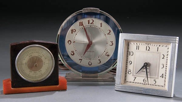 A TAYLOR BAKELITE THERMOMETER, together with a We: A TAYLOR BAKELITE THERMOMETER, together with a Westclox Art Deco blue mirror clock and another Art Deco wind-up clock by New Haven. Height 3 inches. Estimate $100-$200