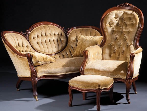 A VICTORIAN MEDALLION BACK SETTEE AND MATCHING AR: A VICTORIAN MEDALLION BACK SETTEE AND MATCHING ARMCHAIR, late 19th century, walnut frame with carved crests and finger mold edge, together with a matching footstool, height 33 inches, length 59 inches