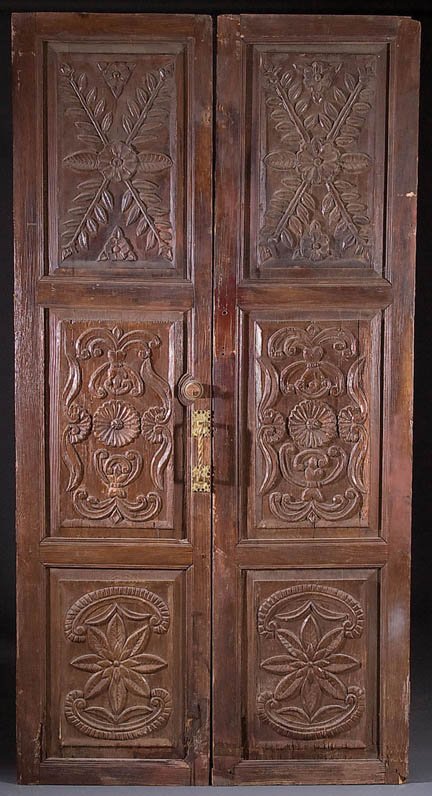 A PAIR OF LARGE MEXICAN CARVED PANEL PINE HACIEND: A PAIR OF LARGE MEXICAN CARVED PANEL PINE HACIENDA DOORS early 20th century, with carved rosettes and foliates. Height 97.5 inches, width 25 inches. Estimate $150-$250