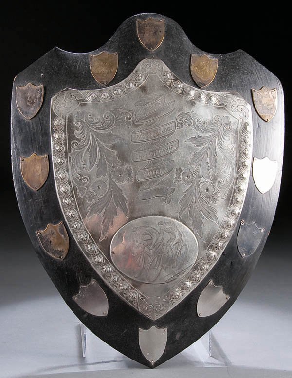 AN INTERESTING SCOTTISH CLACKMANSHIRE BICYCLE CLU: AN INTERESTING SCOTTISH CLACKMANSHIRE BICYCLE CLUB TROPHY SHIELD circa 1900, engraved silvered shield shape trophy on ebonized wood plaque with bicycle race engraved vignette. 17.5 inches x 13.5 inche