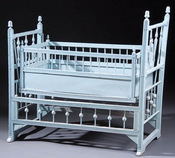 A VICTORIAN STICK AND BALL BABY CRADLE (19th cent: A VICTORIAN STICK AND BALL BABY CRADLE (19th century) Oak with layer painted finish Height 38 inches Width 22 inches Estimate $75-$150