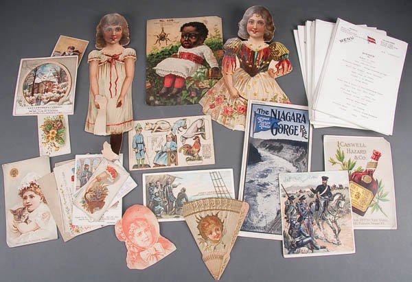 A VINTAGE EPHEMERA AND PAPER DOLL GROUPING over 1: A VINTAGE EPHEMERA AND PAPER DOLL GROUPING over 100 pieces including steamship menus circa 1913, early tourism pamphlets, trade cards and other items. Together with 7 souvenir felt pennants and 6 Vict