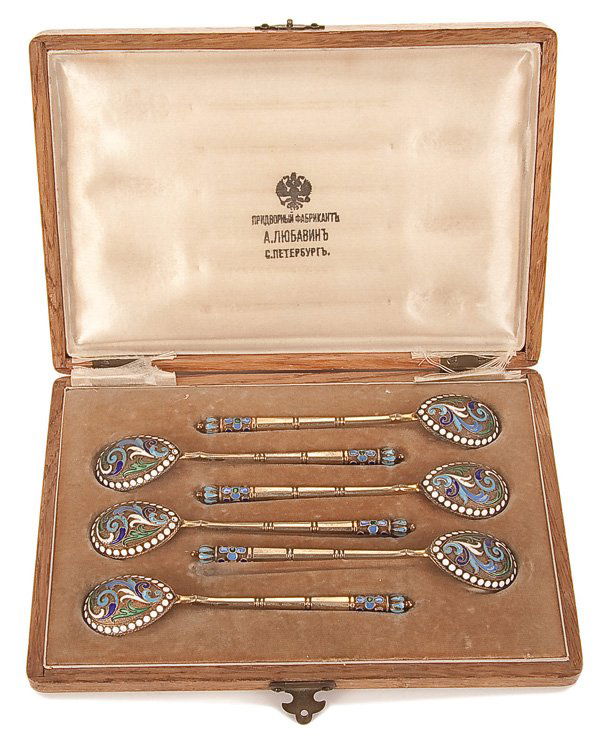 A SET OF RUSSIAN SILVER-GILT AND ENAMEL TEASPOONS: A CASED SET OF SIX RUSSIAN SILVER-GILT AND CLOISONNE ENAMEL TEA SPOONS, ST. PETERSBURG, 1896-1908. The bowls with enameled scrolling foliage decorate element and white enamel beaded border on a stippl