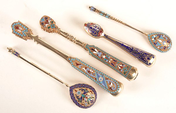 A GROUP OF RUSSIAN SILVER-GILT AND ENAMEL UTENSILS: A GROUP OF FIVE RUSSIAN SILVER GILT, CLOISONNE AND CHAMPLEVE ENAMELED UTENSILS Including three silver gilt and enameled sugar tongs, various makers, together with a cloisonne enameled teaspoon and dem