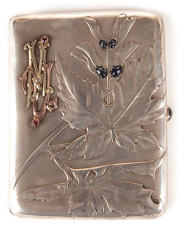A RUSSIAN FABERGE SILVER-GILT CIGARETTE CASE: A FABERGE SILVER-GILT AND GEM-SET CIGARETTE CASE, MOSCOW 1896-1908. The hinged lid with raised leaf design and the petals mounted with four blue cabochons and set with with a two-color gold monogram e