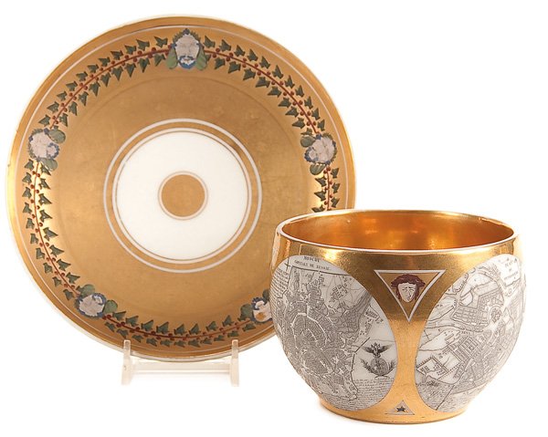 A RUSSIAN PORCELAIN CUP & SAUCER: A FINE AND IMPORTANT PORCELAIN CARTOGRAPHIC BREAKFAST CUP AND SAUCER by The Schoelcher Factory, France, first quarter of the 19th century. The cup of rounded form printed with two circular maps of Mos