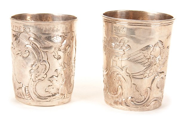 A PAIR OF RUSSIAN SILVER BEAKERS, 18TH CENTURY: A PAIR OF RUSSIAN SILVER BEAKERS, 18TH CENTURY, MOSCOW The sides repoussed with eagles and rococo design. Both hallmarked Moscow, one dated 1766 and other marks. Heights 3 inches (7.7 cm) and 3.25 inc