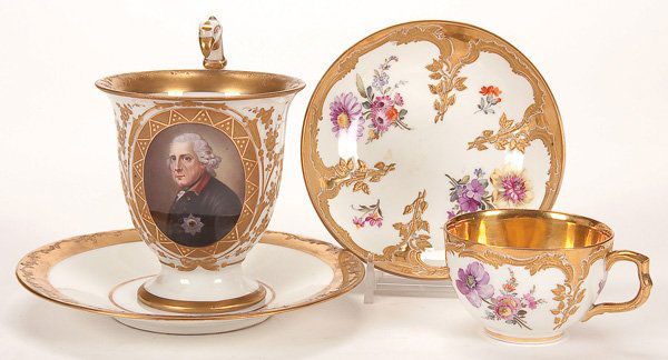 A HAND PAINTED DRESDEN PORCELAIN CUP AND SAUCER: A HAND PAINTED DRESDEN PORCELAIN CUP AND SAUCER, 19TH CENTURY. 'King Frederick II of Prussia' within a tooled gilt cartouche, height 4.25 inches (11 cm). Together with a KPM demi-cup and saucer with h