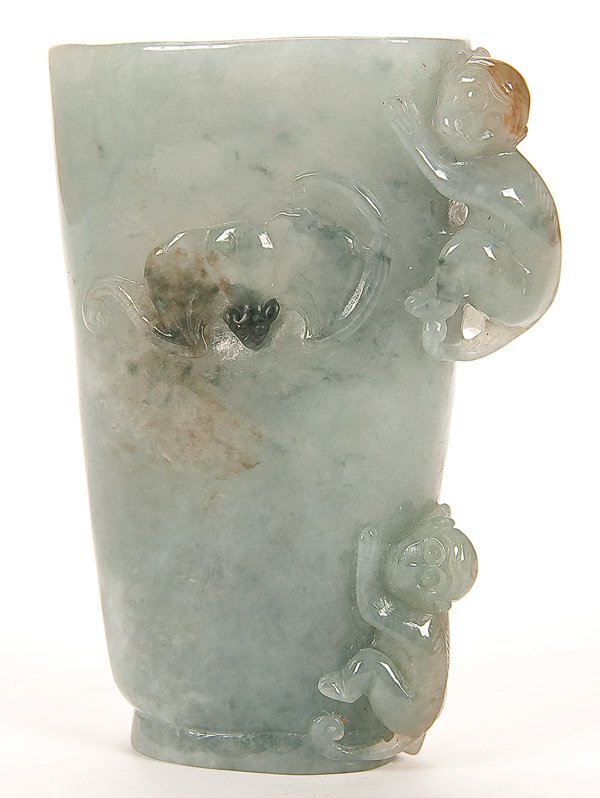A CHINESE CARVED JADE LIBATION CUP: A CHINESE CARVED JADE LIBATION CUP, EARLY REPUBLIC PERIOD. With carved monkeys and bats in green and white nephrite. Height 4 inches. Estimate $400-$600 Euro 300-400