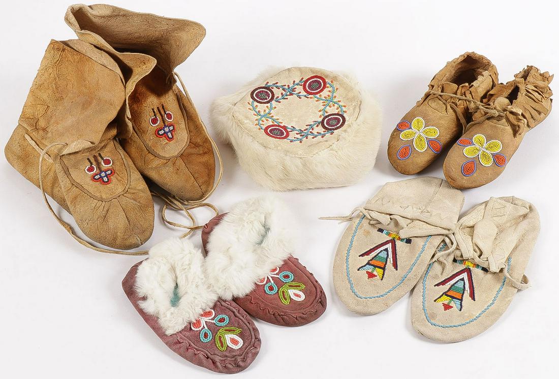 4 BEADED MOCCASINS: 4 BEADED MOCCASINS. Of traditional form, as shown, together with a beaded fur trimmed hat. Greatest length 9.75 inches. SHIPPING NOTICE: Jackson's is your sole and only source for one stop packing an
