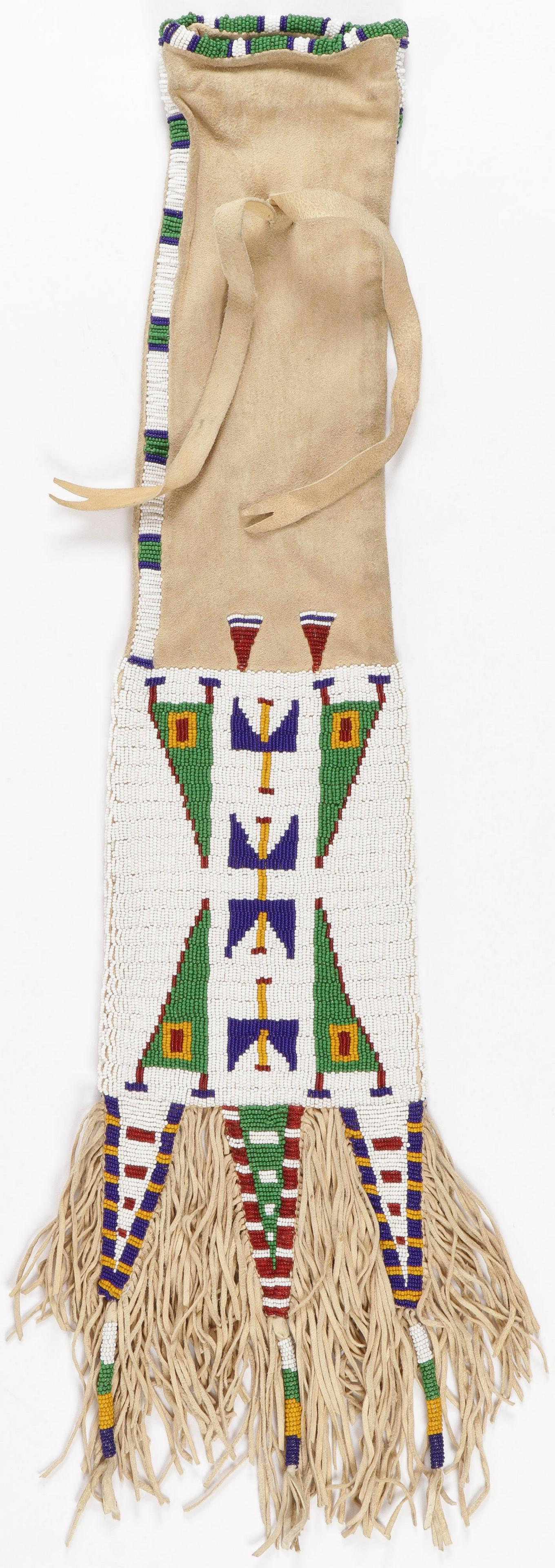 CLASSIC PLAINS STYLE BEADED PIPE BAG: CLASSIC PLAINS STYLE BEADED PIPE BAG. Soft, supple, brain tanned hide with traditional geometric lazy stitched beading. Length (including fringe) 29 inches.SHIPPING NOTICE:Jackson's is your sole and