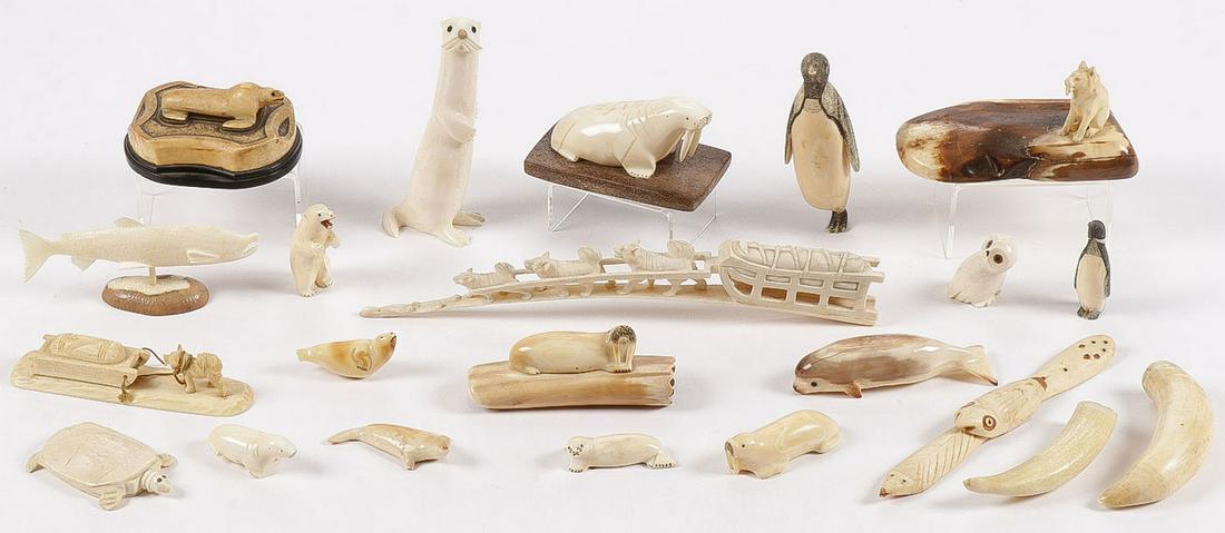 20 VINTAGE ESKIMO CARVINGS: 20 VINTAGE ESKIMO CARVINGS. Comprising 20 individual carvings, including a great stylized seal on shaped base, a standing polar bear, penguin, dog and sled, dogsled team, turtle, otter, walrus, owl an