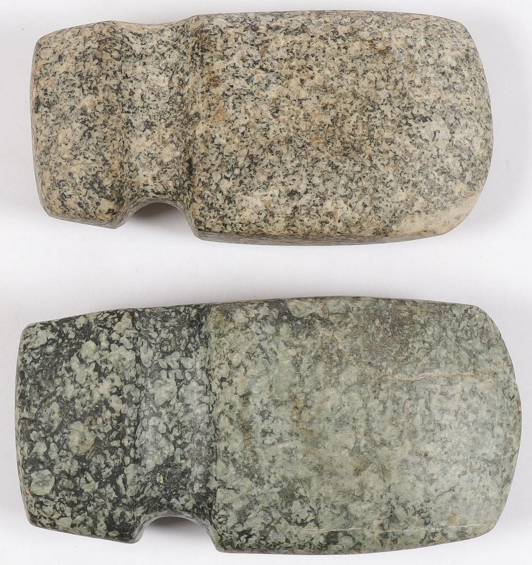 PAIR OF 3/4 GROOVE AXES: PAIR OF 3/4 GROOVE AXES. Each in medium to high polish granite with slightly fluted base. More than likely modern, but well modeled. Greatest length 6.75 inches.SHIPPING NOTICE:Jackson's is your sol