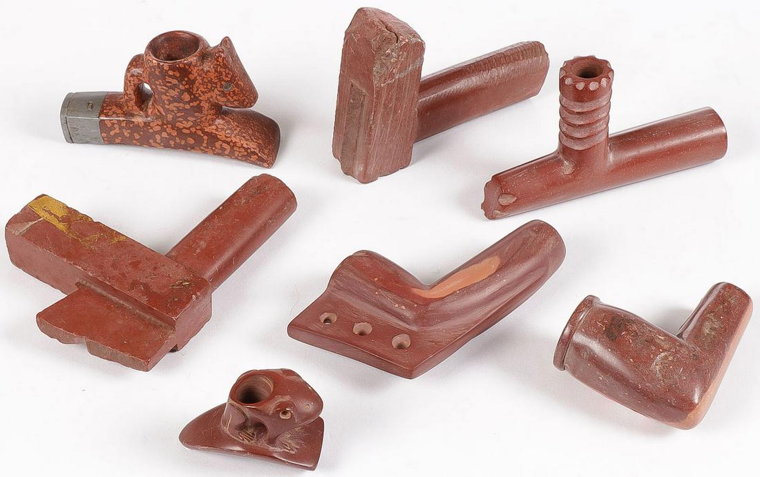 7 CATLINITE PIPES: 7 CATLINITE PIPES. Comprising seven various Catlinite (pipestone) pipes of various shapes, forms, and sizes. Including one with pewter banding and a hand-held frog effigy pipe, one with Illinois colle