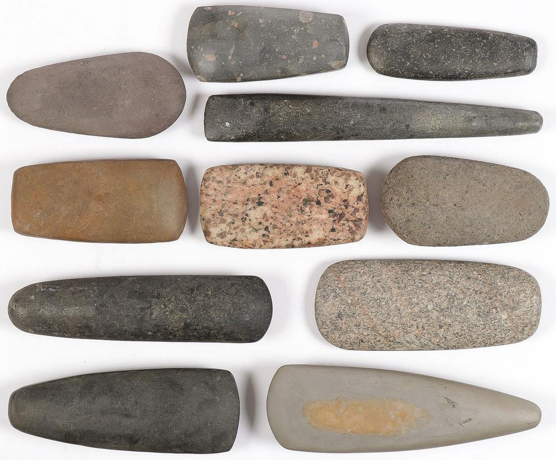 11 POLISHED STONE TOOLS: 11 POLISHED STONE TOOLS. Comprising eleven individual polished stone celts of various materials, including porphyry, speckled granite, and slate. Likely all post-historic. Greatest length 10.5 inches.