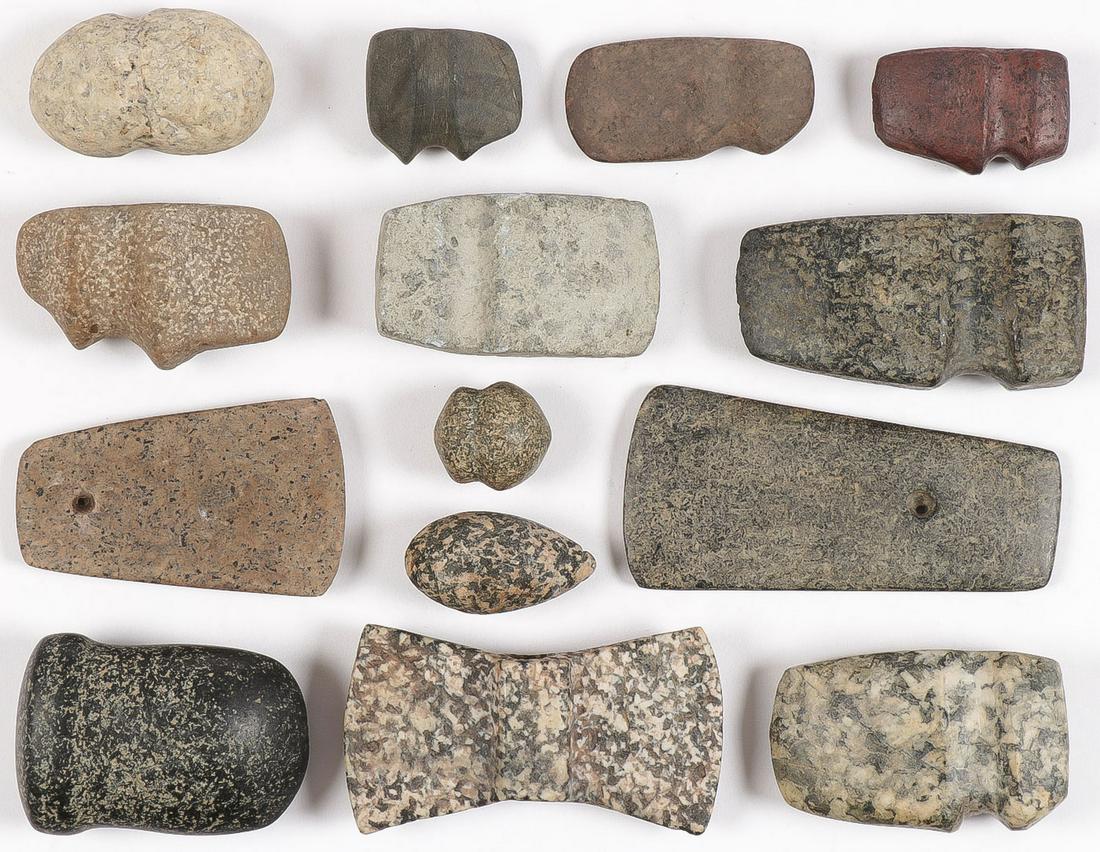 14 POLISHED STONE TOOLS: 14 POLISHED STONE TOOLS. Comprising 14 small or miniature size stone tools, including axe heads, a bannerstone, two celt pendants, and plumb stones. Made from a variety of material. Perhaps a few preh