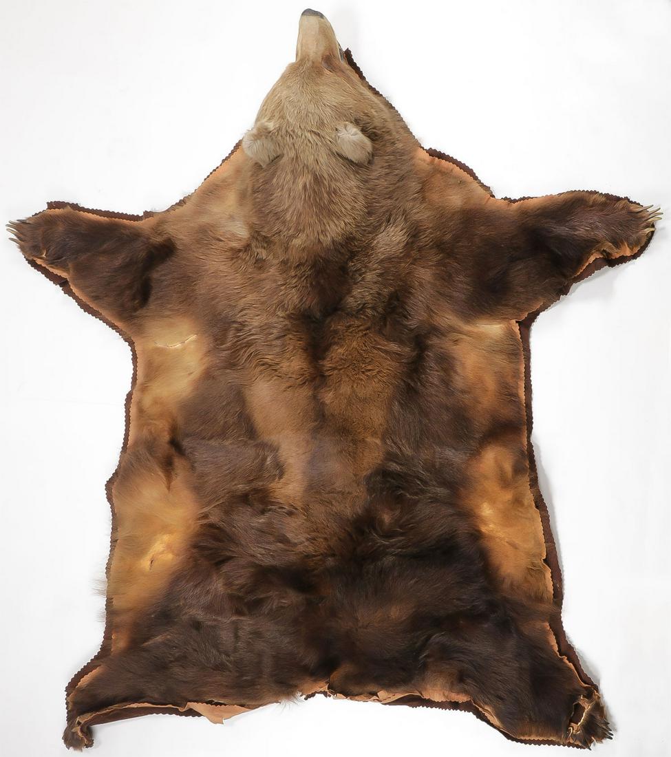 AN IMPRESSIVE KODIAK BEAR RUG MOUNT: AN IMPRESSIVE KODIAK BEAR RUG MOUNT. A full body taxidermy Kodiak bear rug, 92 inches x 90 inches. Shot in Alaska, 1963.SHIPPING NOTICE:Jackson's is your sole and only source for one stop packing an