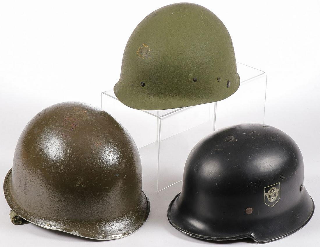 3 WWII HELMETS: 3 WWII HELMETS. Comprising a German WWII M34 fire/police helmet (missing comb), with de-nazified police shield and national shield obscured. A US front seam helmet with Westington House liner and a re