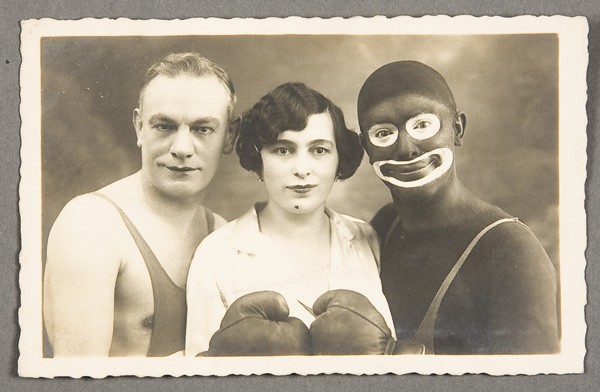 BLACK MEMORABILIA: BOXING MINSTREL POSTCARD: AN AUSTRIAN BOXING MINSTREL TROUPE REAL PHOTO POSTCARD circa 1930. Of two men and a woman. Postally unused. Very good to excellent condition.