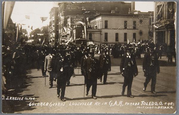 BLACK MEMORABILIA: MILITARY REAL PHOTO POSTCARD: A GAR COLORED (BLACK) GUARDS PARADE REAL PHOTO POSTCARD postmarked 1909. Depicting black guards of the Louisville, KY GAR (Grand Army of the Republic) in uniform at the 1909 Toledo, OH parade. Publish