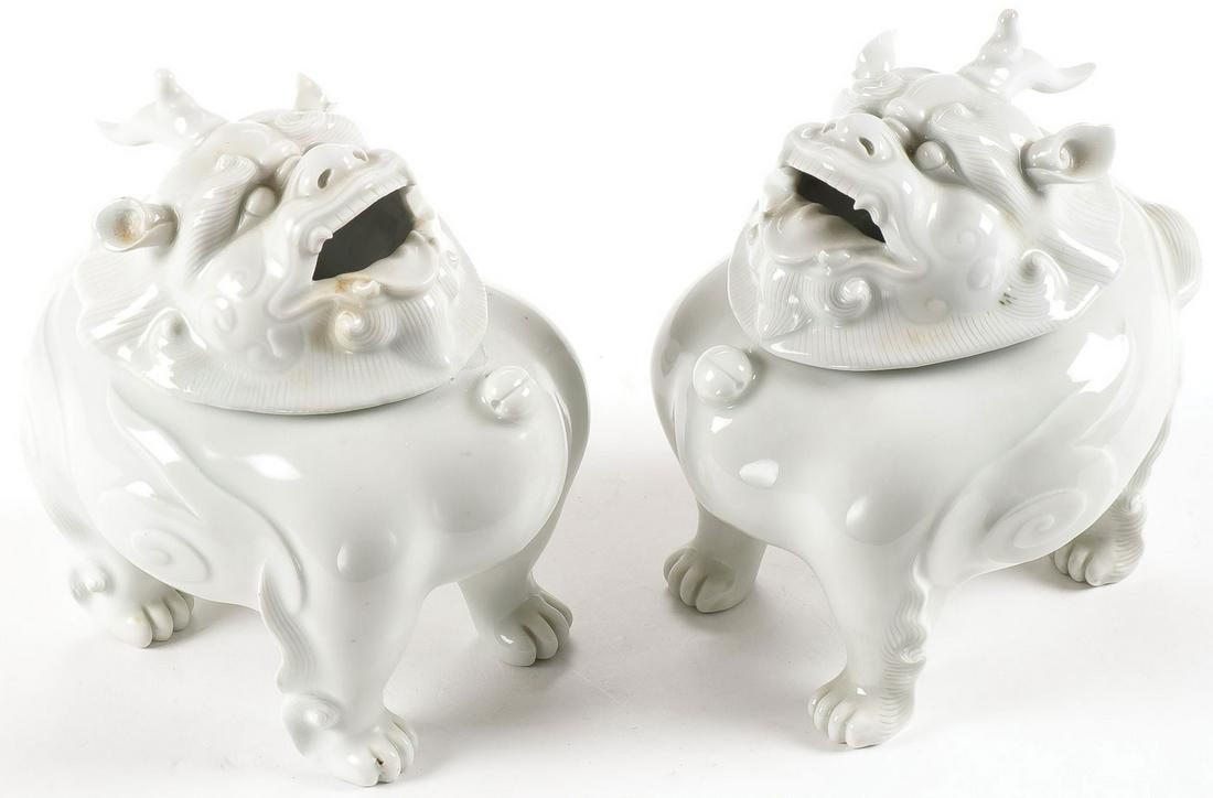 PAIR OF HIRADO PORCELAIN CENSERS, MEIJI: PAIR OF HIRADO PORCELAIN CENSERS, MEIJI. Each molded in the form of a shishi, the base a lion's sturdy body, the oval rim supporting a lid separately molded as a horned lion's mask, its mouth open to 