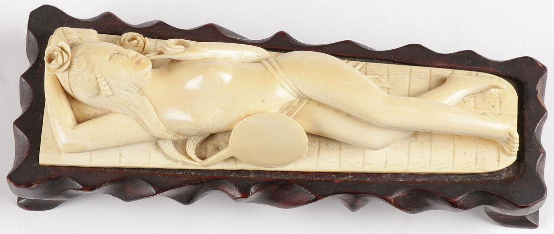 A CHINESE CARVED DOCTOR'S MODEL C. 1920: A CHINESE CARVED DOCTOR'S MODEL C. 1920. Depicting a carved reclining nude woman on large leaf-form mat with mirror and blossom formed vase. Underside signed with three-character Archaic mark and on c