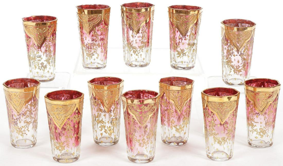 UNUSUAL CASED LIQUEUR GLASSES 19TH C: UNUSUAL CASED LIQUEUR GLASSES 19TH C. Comprising a cased set of 12 ruby flashed and heavily gilt decorated liqueur glasses, one with the original label on underside R & K Austria. Contained in its cus