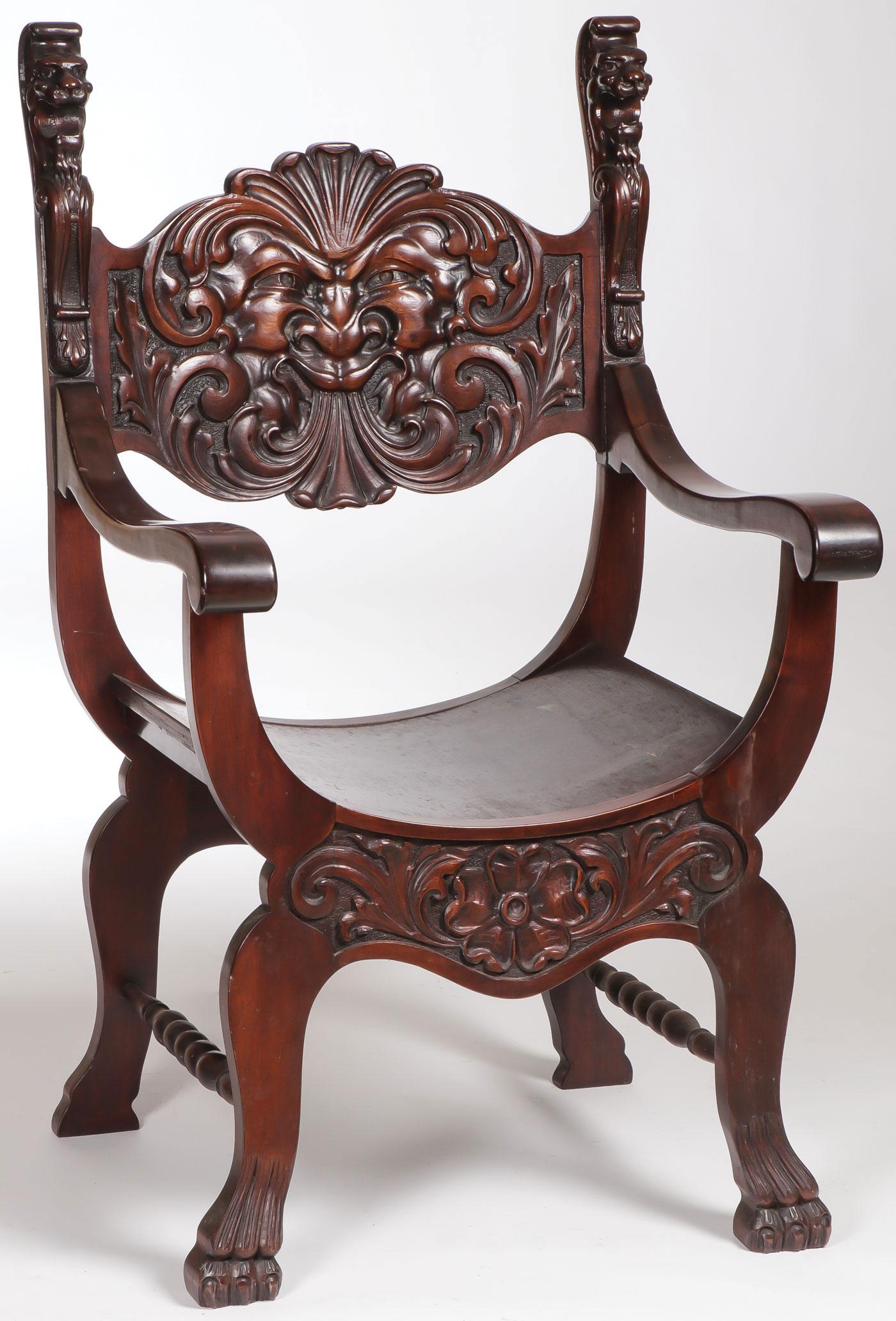 FINE CARVED MAHOGANY SAVONAROLA CHAIR C. 1890: FINE CARVED MAHOGANY SAVONAROLA CHAIR C. 1890. Comprising a large ornate backrest with carved face and with carved lionhead finials giving way to scroll arms all above four cabriole legs connected by