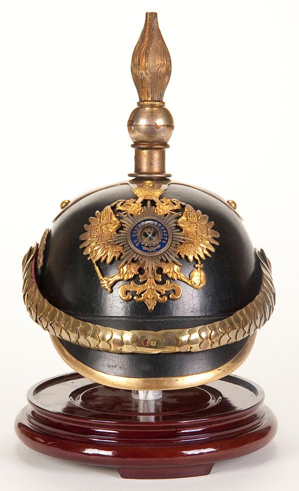 IMPERIAL RUSSIAN CORPS DU PAGE SPIKED HELMET: AN IMPERIAL RUSSIAN CORPS DU PAGE SPIKED HELMET, circa 1900. Black lacquered body with leather visors. Brass eagle plate with applied silver and enamel Guard Star. With brass removable spike on a cruc