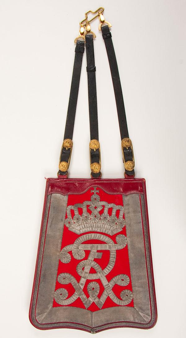 IMPERIAL GERMAN PRUSSIAN OFFICER SABRETACHE: AN IMPERIAL GERMAN PRUSSIAN HUSSAR OFFICER'S SABRETACHE, circa 1910. Leather pouch with red leather scalloped flap covered in red wool with silver bullion braid trim and crowned 'FWR' cipher. Complete