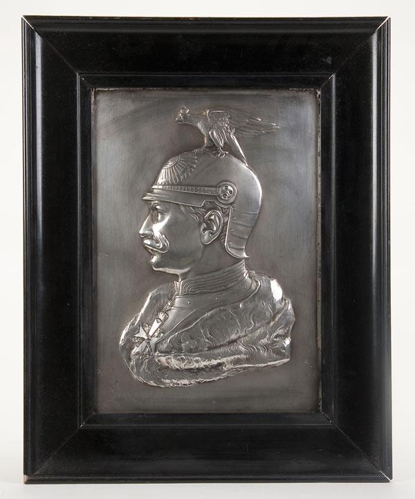 PAIR OF IMPERIAL GERMAN KAISER WILHELM II PLAQUES: A PAIR OF IMPERIAL GERMAN KAISER WILHELM II SILVERED PLAQUES, CIRCA 1915. Comprising two high relief silvered metal plaques depicting the Kaiser in left facing profile, one depicting the Kaiser with h