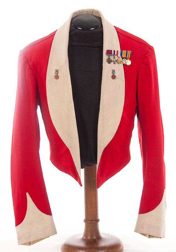 BRITISH MESS DRESS UNIFORM: A BRITISH MESS DRESS JACKET NAMED TO A VICTORIA CROSS WINNER. Lt. Colonel Harry Daniels, VC. Red wool jacket with white shawl collar and pointed cuffs. Interior has a tailor's label named 'Capt. H. Da