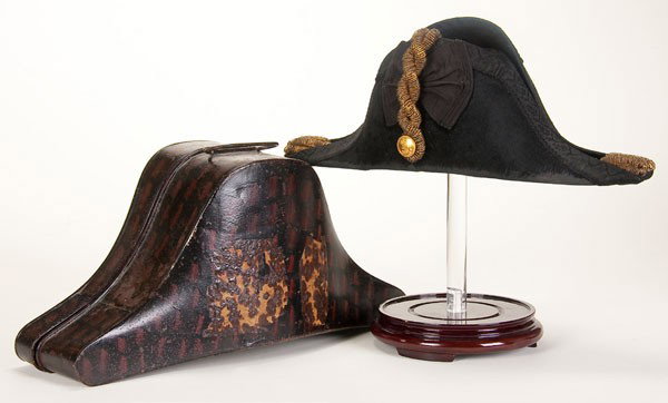 BRITISH EDWARDIAN NAVAL OFFICER'S CHAPEAU: A BRITISH EDWARDIAN NAVAL OFFICER'S CHAPEAU. Black felt, silk trim and cockade with gold bullion cords and tassels, King's crown and anchor button. Lined in white silk with embossed maker's label. Whi