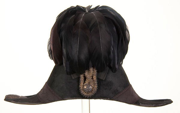 BRITISH EDWARDIAN ERA DRESS CHAPEAU: A BRITISH EDWARDIAN ERA DRESS CHAPEAU, most likely that of a government official. Black felt with matching silk trim and cockade with silver cord and button. Corner with one silver tassel, second tass