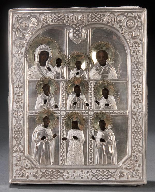 RUSSIAN ICON: MULTIPLE SAINTS: A RUSSIAN ICON WITH MULTIPLE SAINTS, overlaid with a silver repousse riza with silver-gilt applied haloes. Hallmarked St. Petersburg, dated 1881, indistinguishable maker's mark and 84 silver standard.