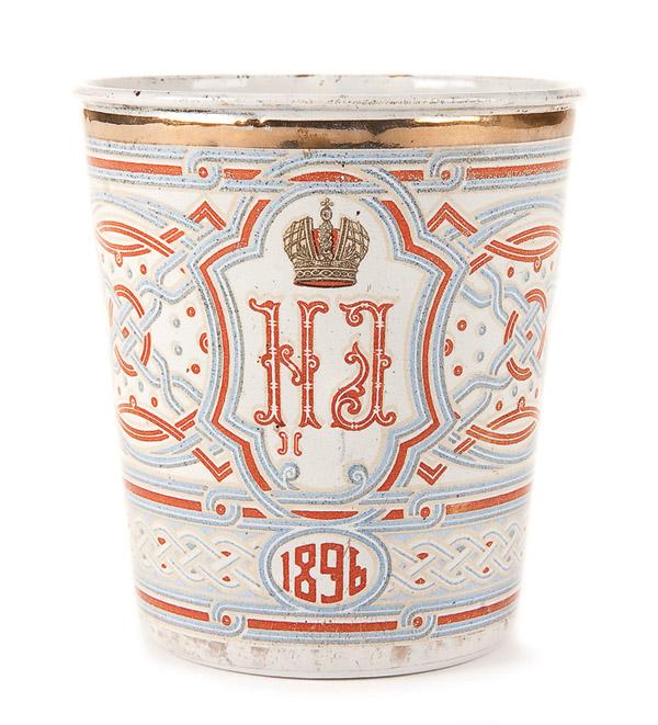 RUSSIAN CORONATION BEAKER: A TSAR NICHOLAS II ENAMELED CORONATION BEAKER, 1896. The so-called 'Blood Cup', overall enameled with strapwork, gilt rim, the Imperial double-headed eagle and the cipher of Nicholas II beneath the Im