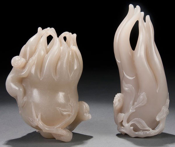 2 ORIENTAL JADE CITRONS: TWO CHINESE CARVED WHITE JADE CITRONS 20th century. The pierced "Buddhas hand" citron form with scrolling branches, one with a climbing monkey figure. Height 4.25 inches & 5.25 inches (10.3 & 13.2 cm)
